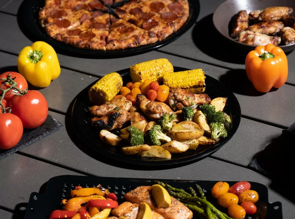 Oscarware® 16” Round Porcelain Coated Grill Topper from the grill to the table.